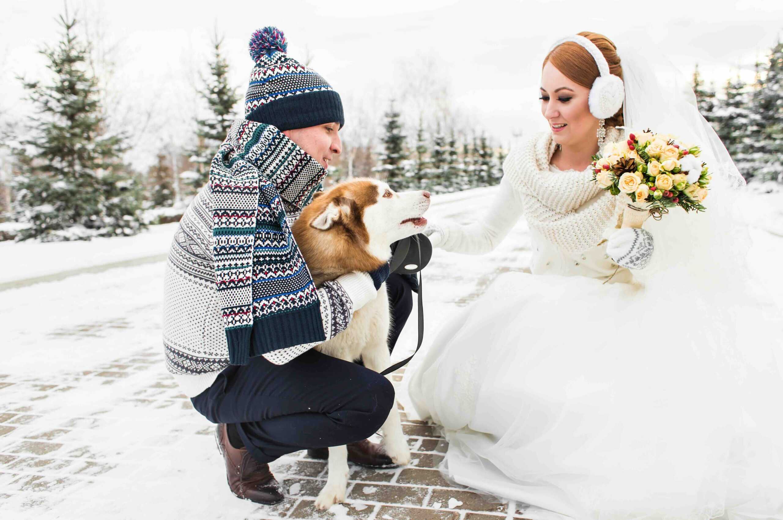 Young couple with a dog on winter walk